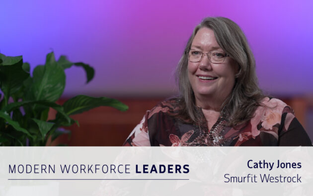 A woman with long gray hair and glasses smiles while seated indoors, next to a green plant. Text reads "Modern Workforce Leaders" and "Cathy Jones, Smurfit Westrock," highlighting expertise in workforce management software.